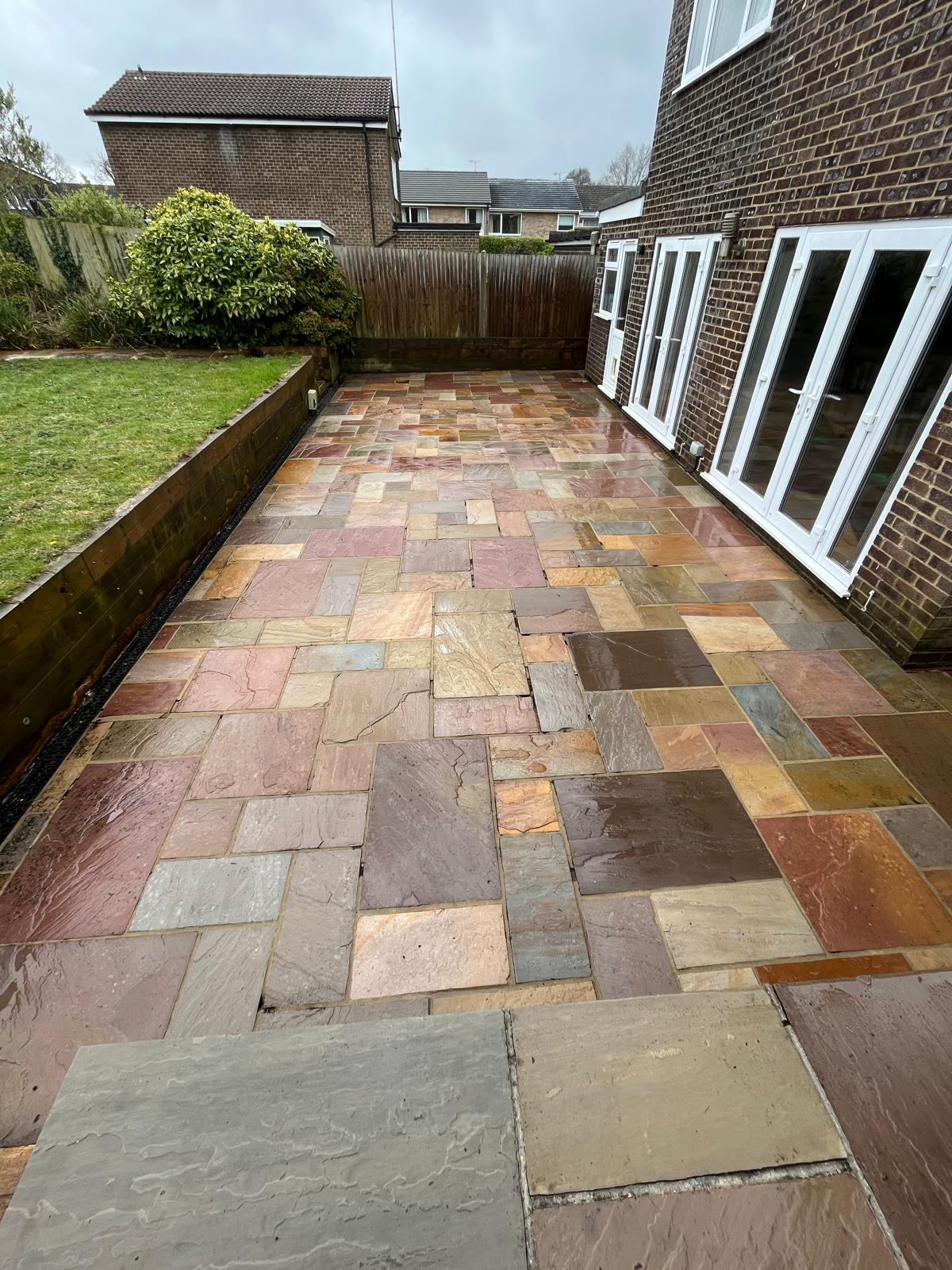 A freshly softwashed and restored natural sandstone patio in Sussex